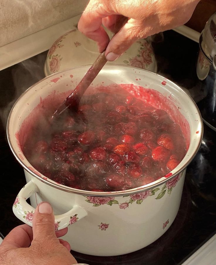 a person is stirring some food in a pot