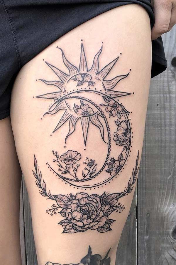 a woman's thigh with sun and moon tattoos on it