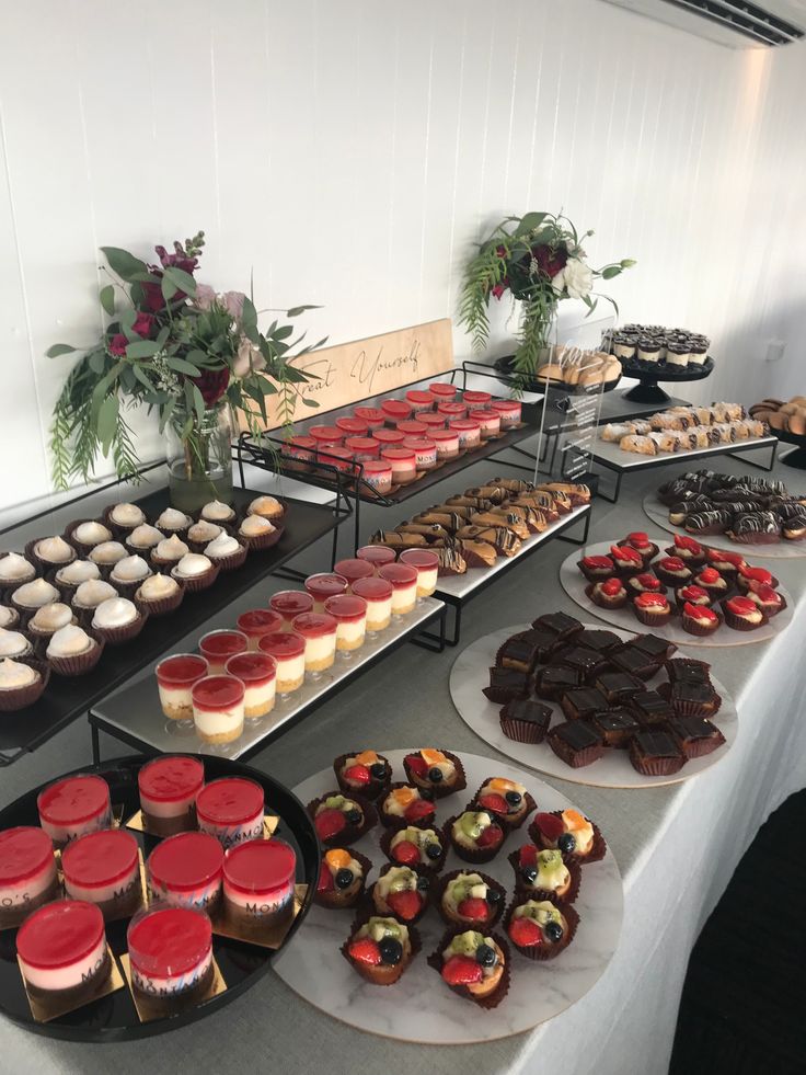 a table topped with lots of different types of cakes and cupcakes next to each other