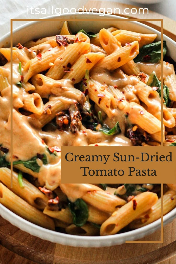 creamy sun - dried tomato pasta in a white bowl