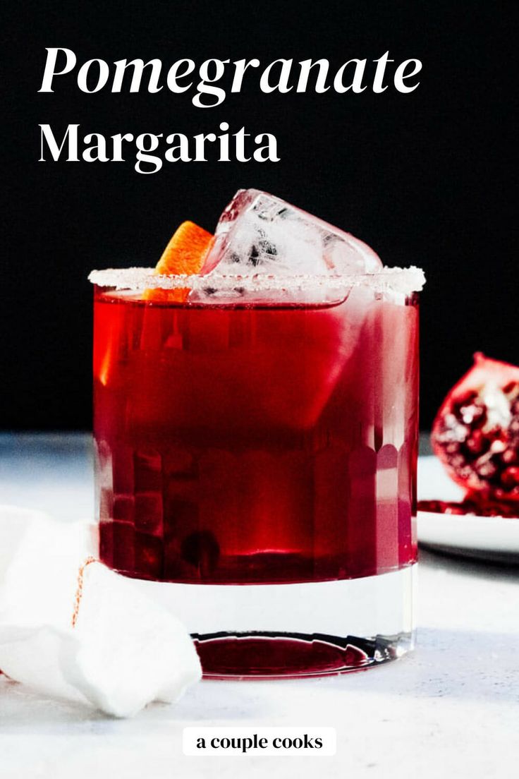 pomegranate margarita cocktail in a glass garnished with an orange slice