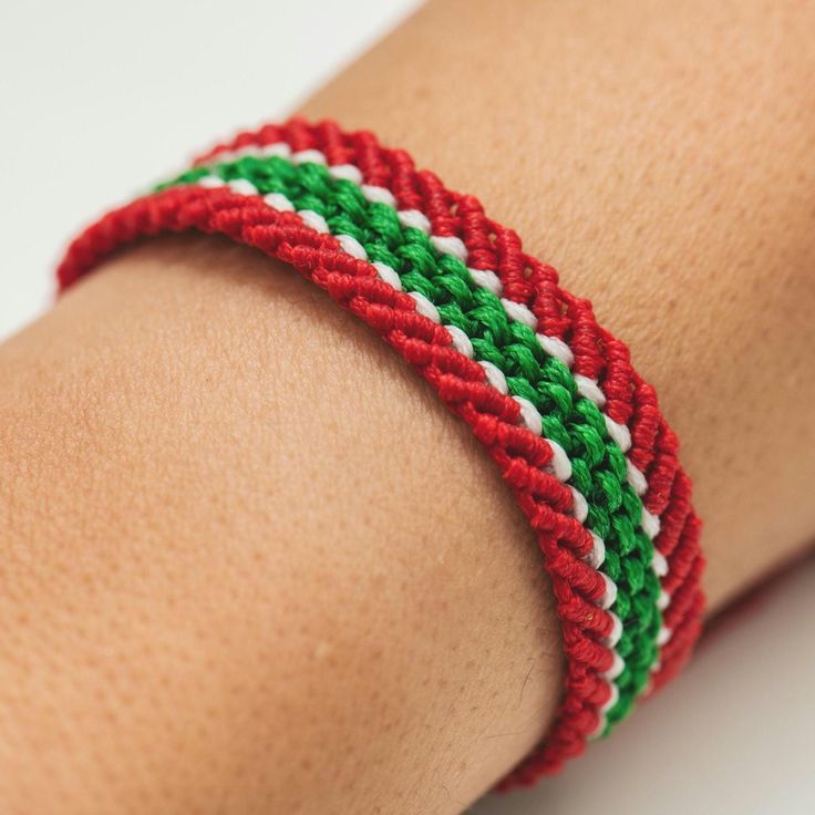 a red, green and white bracelet on someone's arm