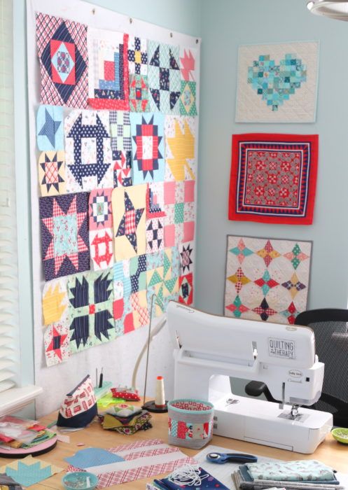 a sewing machine sitting on top of a table next to quilts and other items