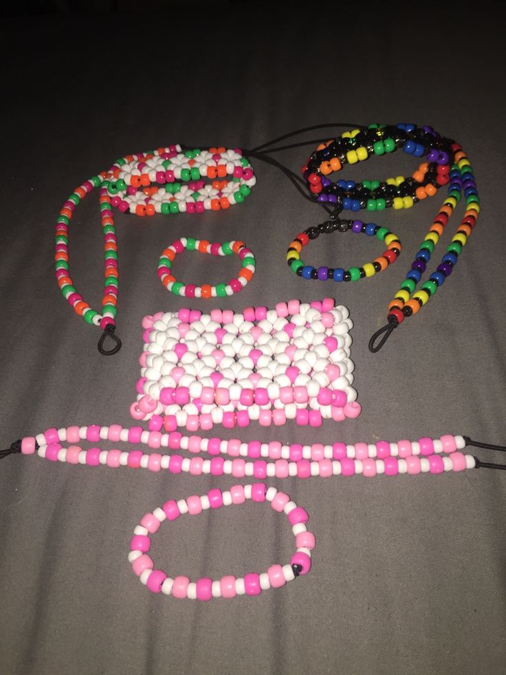 some beads and necklaces are laying out on the floor