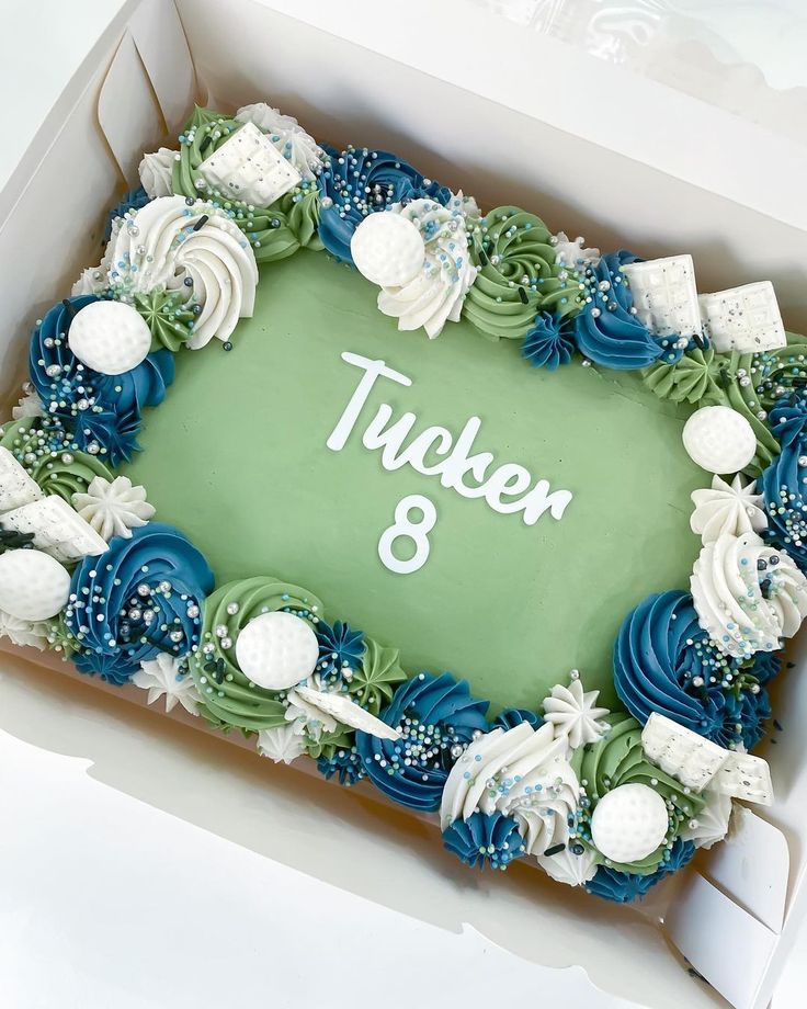 there is a cake in the box that says trucken and decorated with seashells