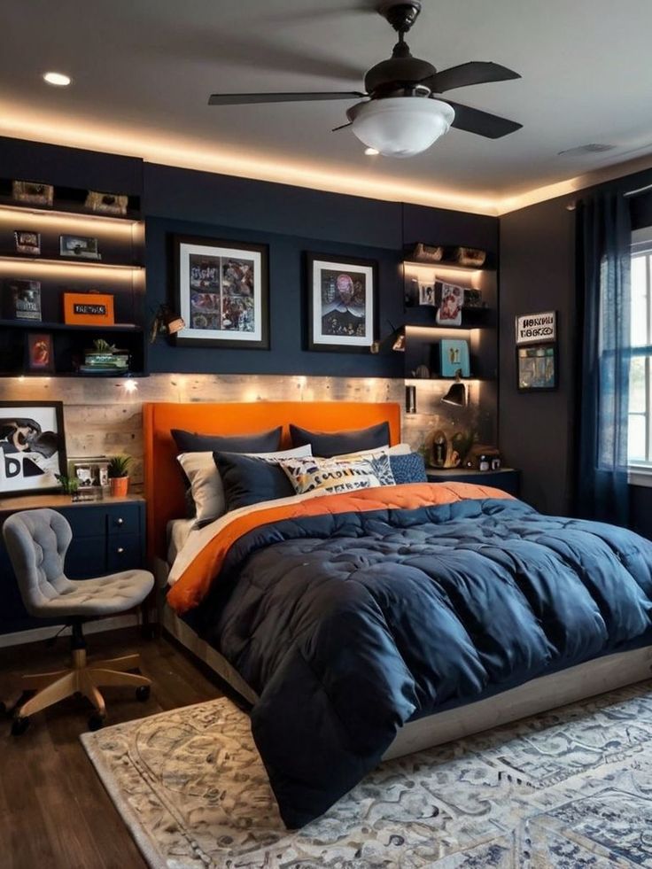 a bedroom with dark blue walls, orange accents and pictures on the wall above the bed