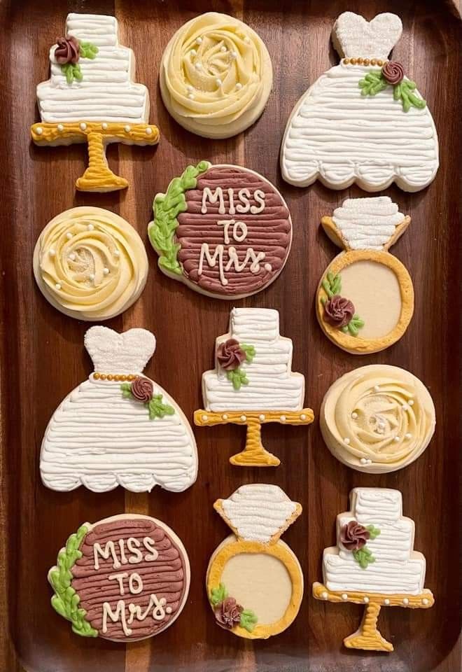 decorated cookies are arranged on a tray with the words miss to mr and mrs written on them