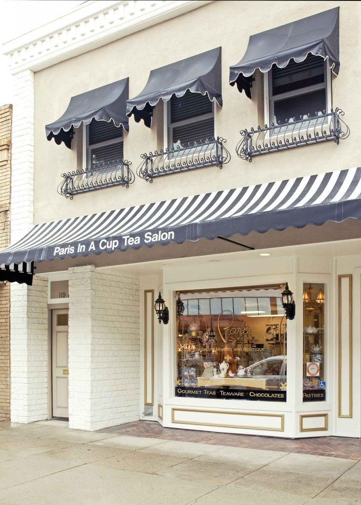 a store front with black and white awnings