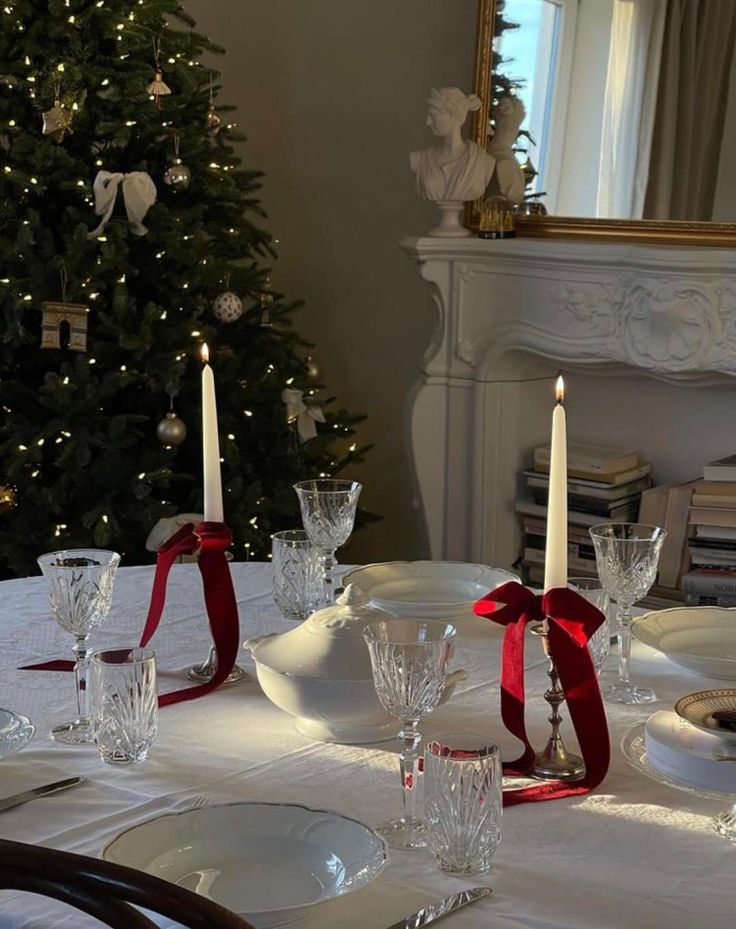 a dining room table set for christmas dinner