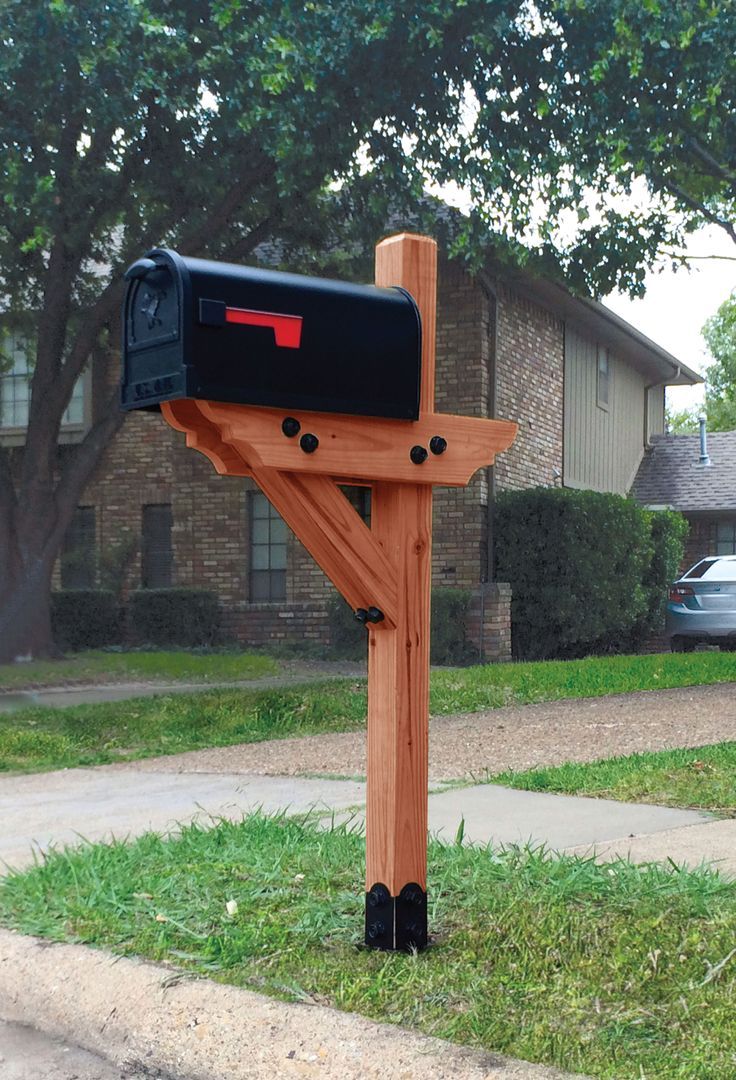 a wooden post with a mailbox attached to it