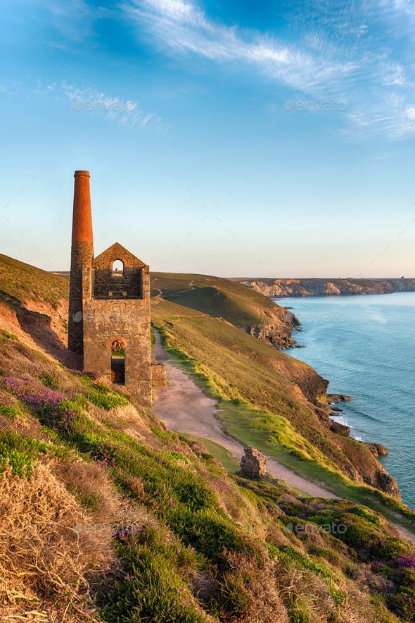 an old brick building on the edge of a cliff overlooking the ocean - stock photo - images