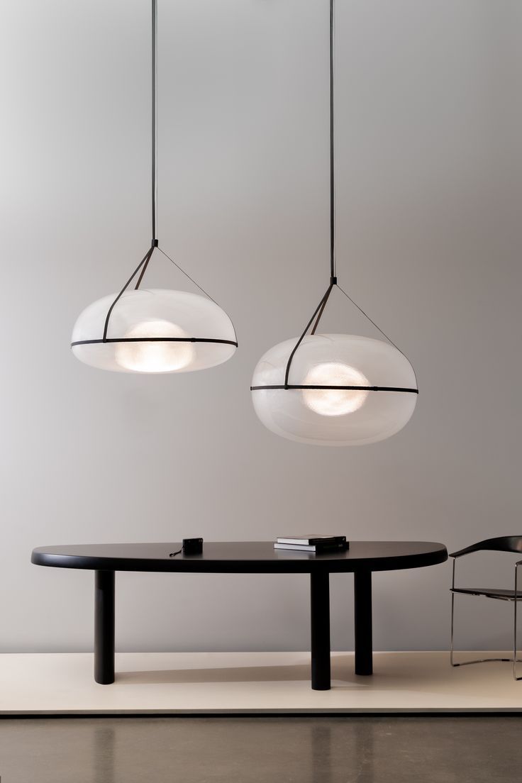 three lights hanging over a table in a room