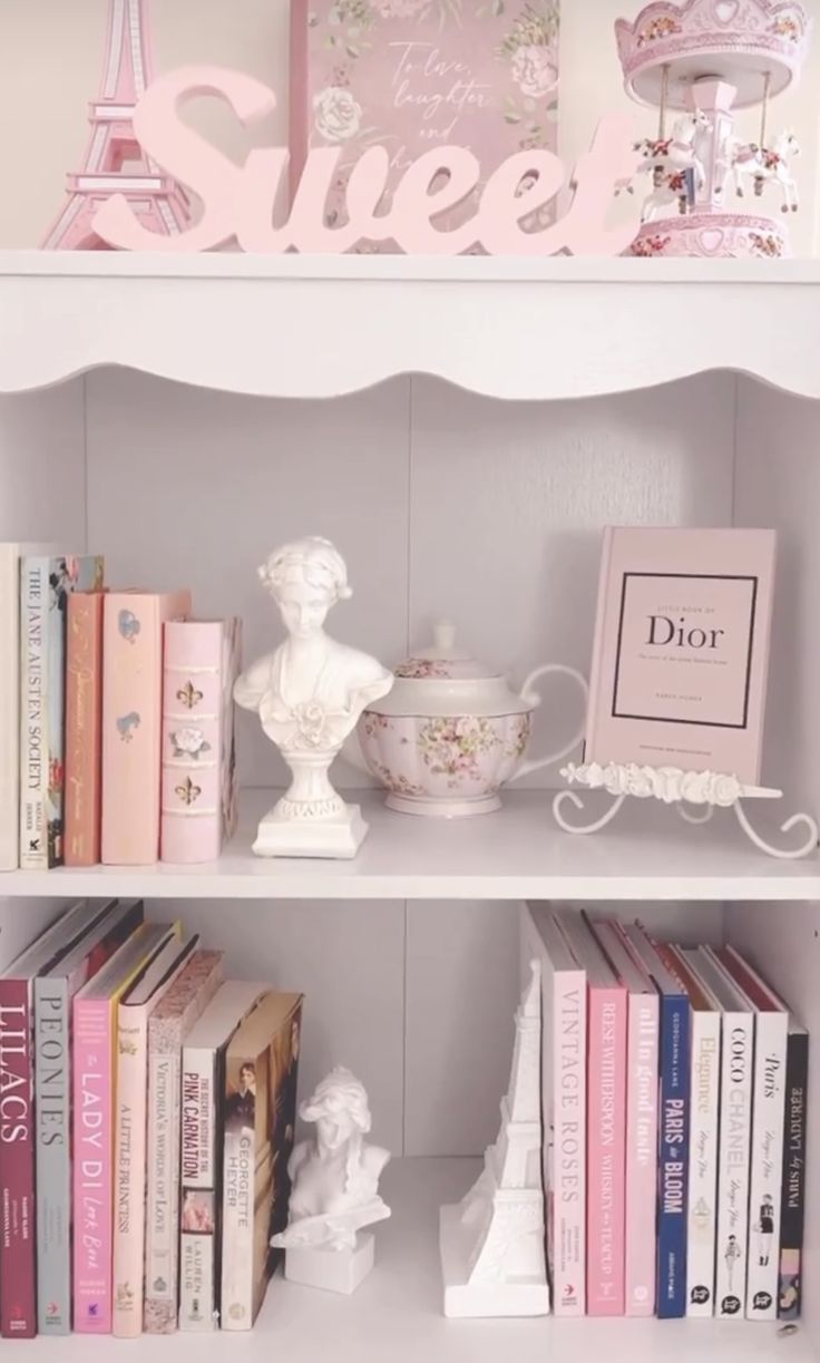 a book shelf filled with lots of books next to a pink and white sign that says sweet