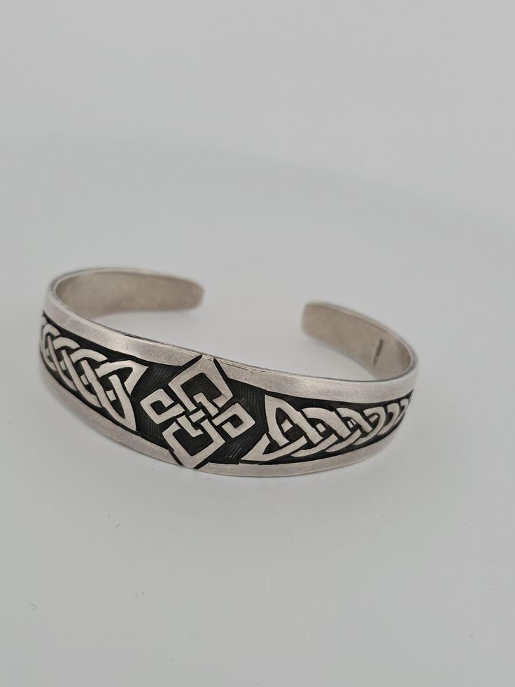 Elevate Your Style with this Exquisite Sterling Silver Celtic Cuff Bracelet Add a touch of ancient elegance to your jewelry collection with this stunning Sterling silver Celtic design cuff bracelet. Expertly crafted from high-quality Sterling silver, this bracelet features an intricate Celtic knot pattern that showcases exceptional craftsmanship and attention to detail. *Timeless Design* The Celtic knot design is a timeless and iconic motif that symbolizes unity, eternity, and spiritual growth. Celtic Bracelet, Knot Pattern, Celtic Knot Designs, Celtic Design, Knot Design, Celtic Designs, Celtic Knot, Spiritual Growth, Cuff Bracelet