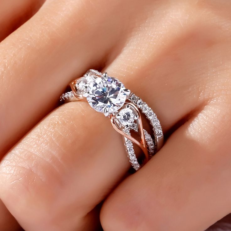 a woman's hand with a diamond ring on top of her finger and an engagement band