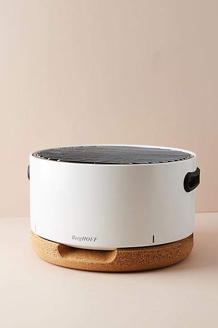 a white and black speaker sitting on top of a table