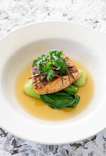 a white bowl filled with food on top of a table