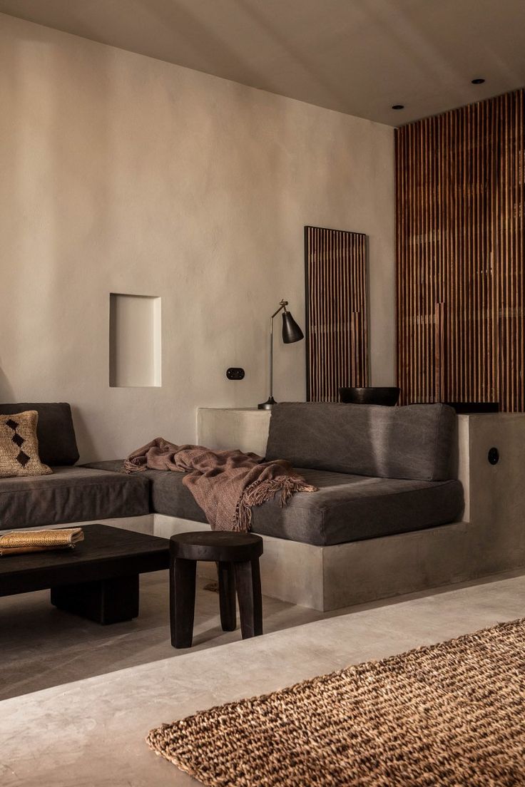 a living room filled with lots of furniture next to a wall mounted tv on top of a wooden shelf