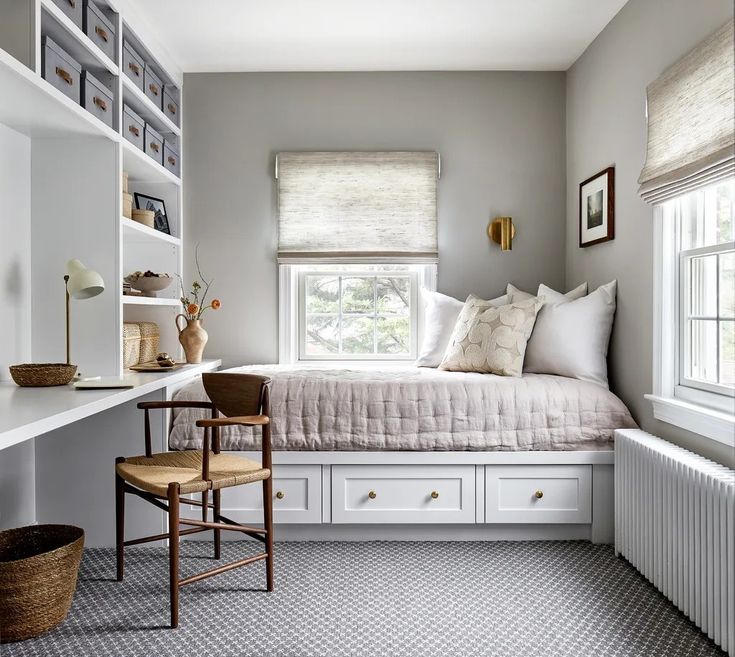 a bedroom with gray walls and white furniture