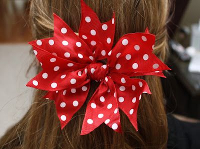 a red and white polka dot hair bow