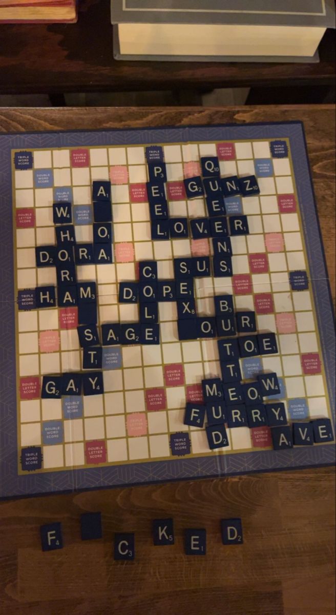 a scrabble game is shown on the floor with words spelled in blue and red