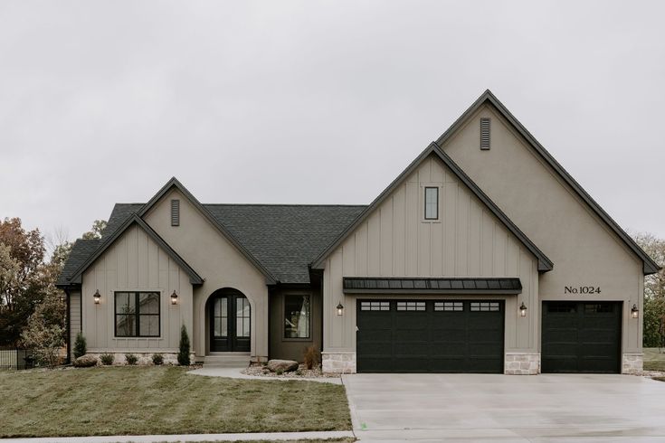 a large house with two garages on the front