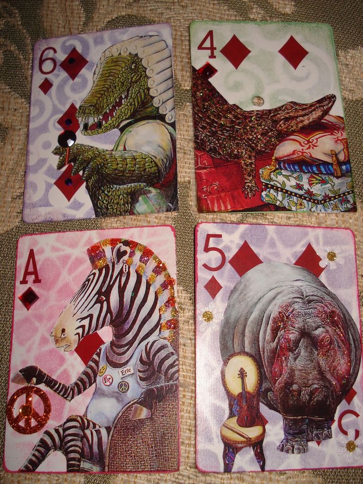 four playing cards with different animals on them