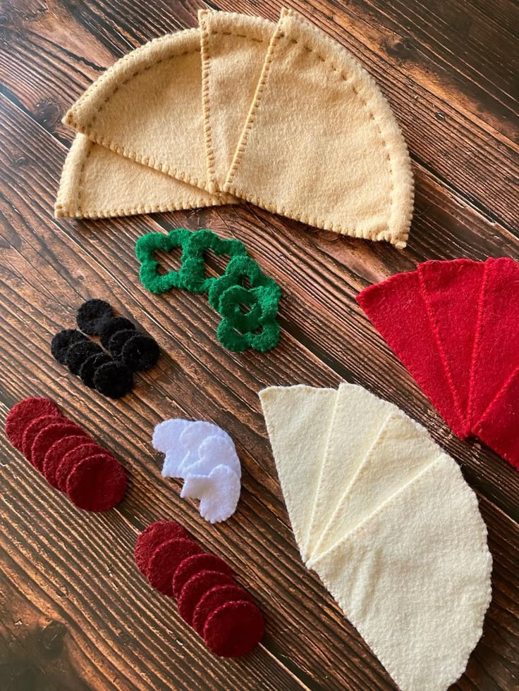 several felt pieces laid out on top of a wooden table