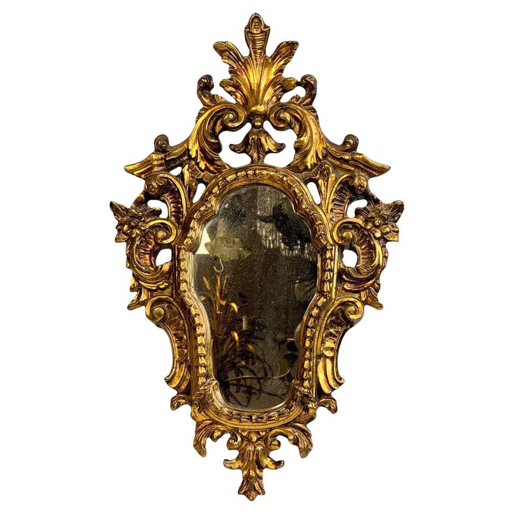 an ornate gold framed mirror with a painting on it