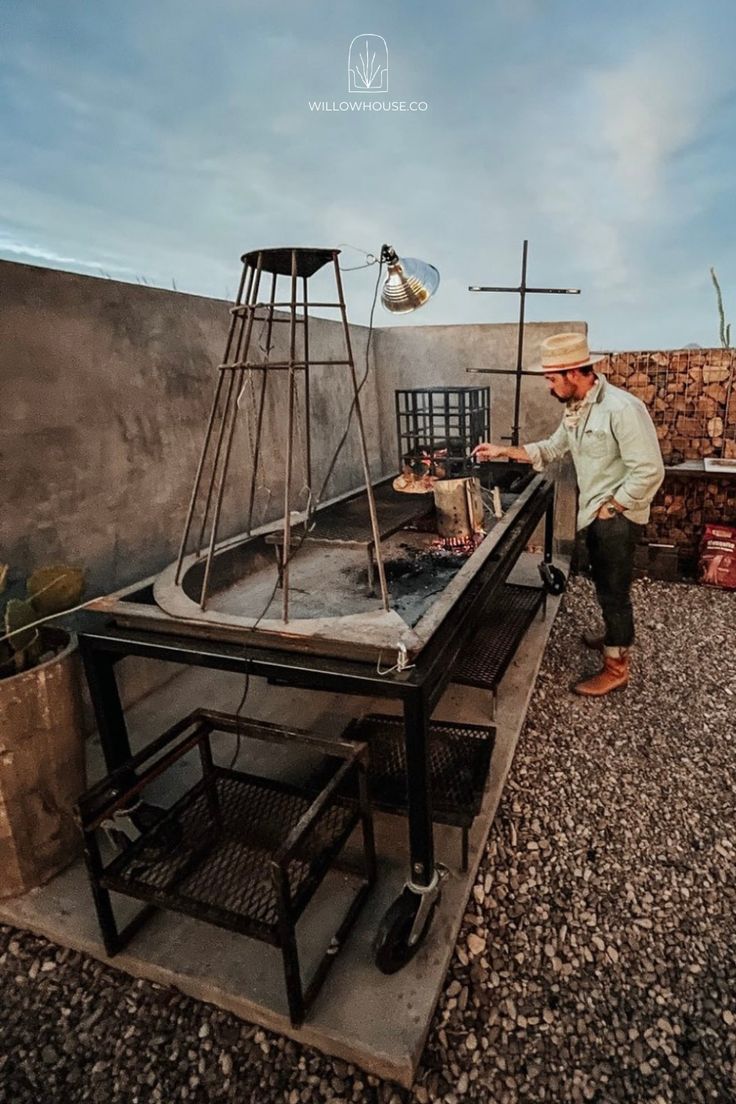 a man is cooking food on an outdoor grill