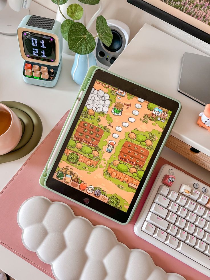 a tablet computer sitting on top of a desk next to a keyboard and mouse,