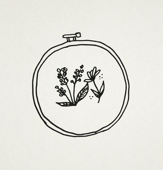 a black and white drawing of flowers in a round frame