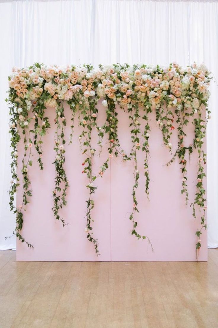 the backdrop is decorated with flowers and vines for a dance or wedding reception at this venue