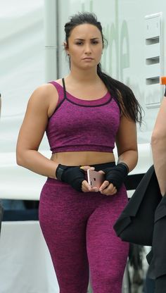 a woman in purple sports bra top and leggings