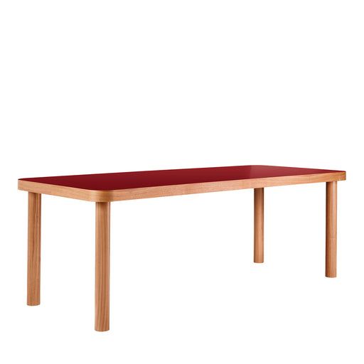 a red table sitting on top of a white floor next to a wooden frame and legs