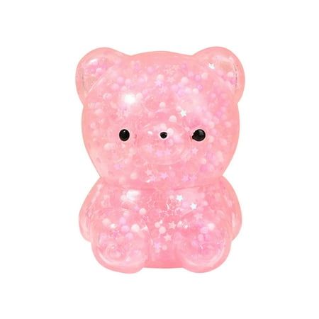 a pink teddy bear with black eyes on it's face, sitting in front of a white background