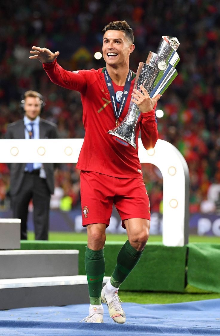 the soccer player is celebrating with his trophy