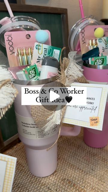 two pink cups filled with items on top of a table