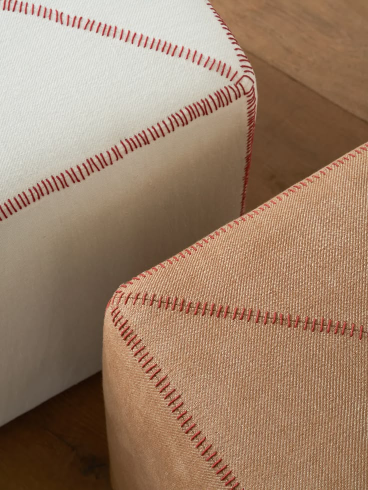 close up view of the back and sides of a chair with red stitching on it