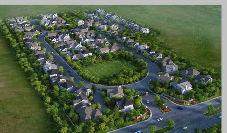 an aerial view of a soccer field in the middle of a neighborhood with houses and trees