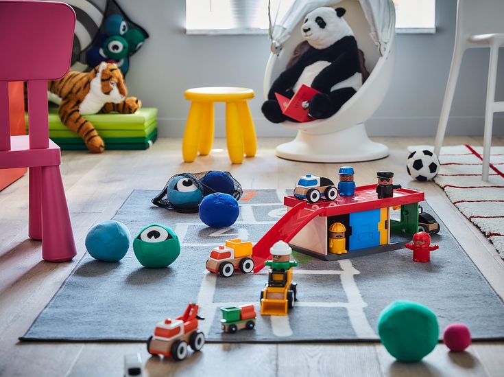 a room filled with lots of toys and stuffed animals on top of carpeted floor