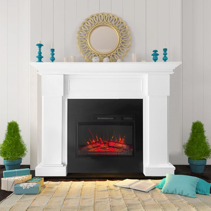 a white fireplace with a mirror above it