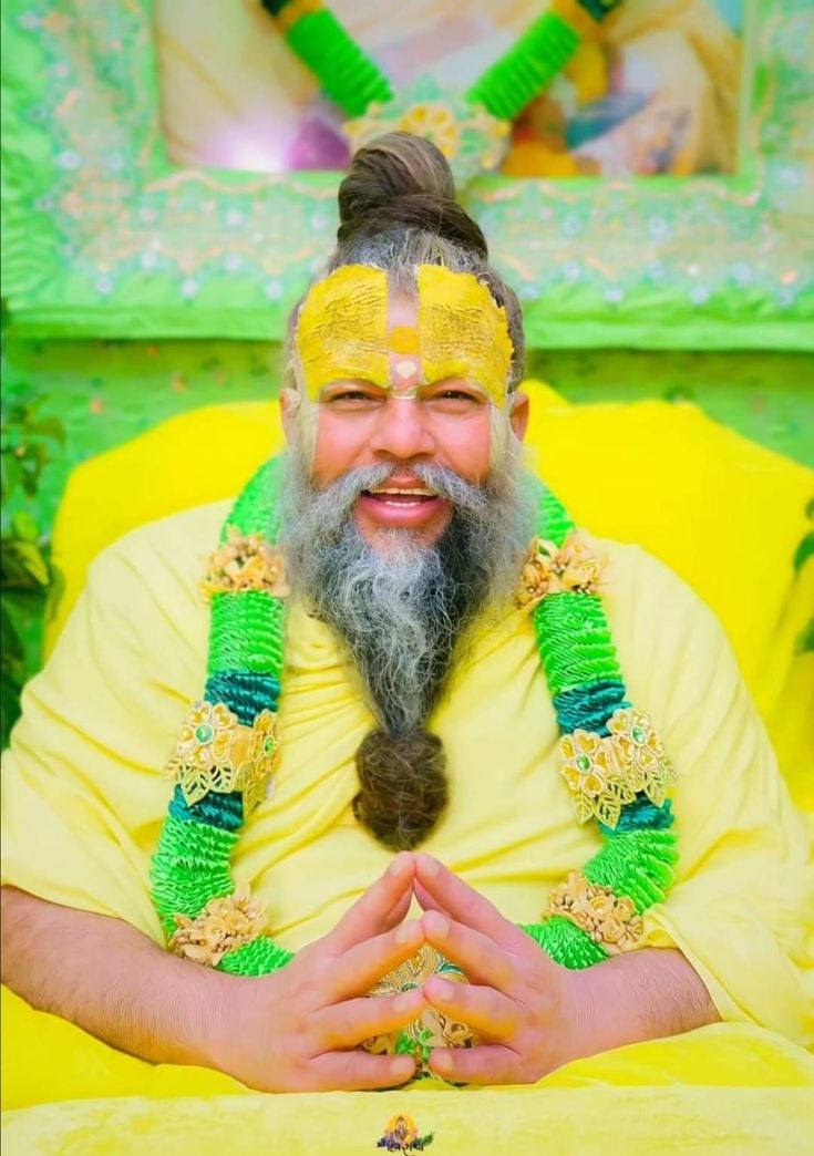 a man with long hair wearing yellow and green garlands