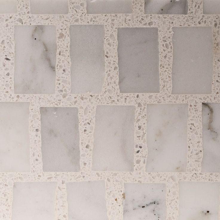 white marble tile with squares and dots on it