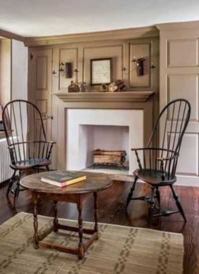 a living room with two chairs and a fire place