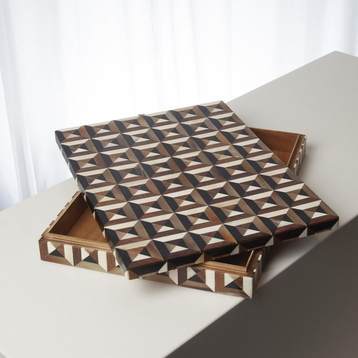 two wooden boxes sitting on top of a white table next to a curtained window