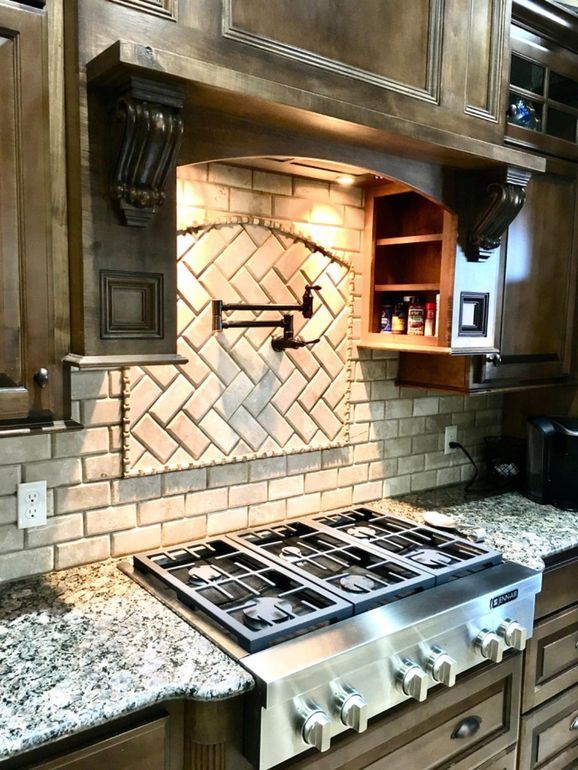 a stove top oven sitting inside of a kitchen next to wooden cabinets and counter tops