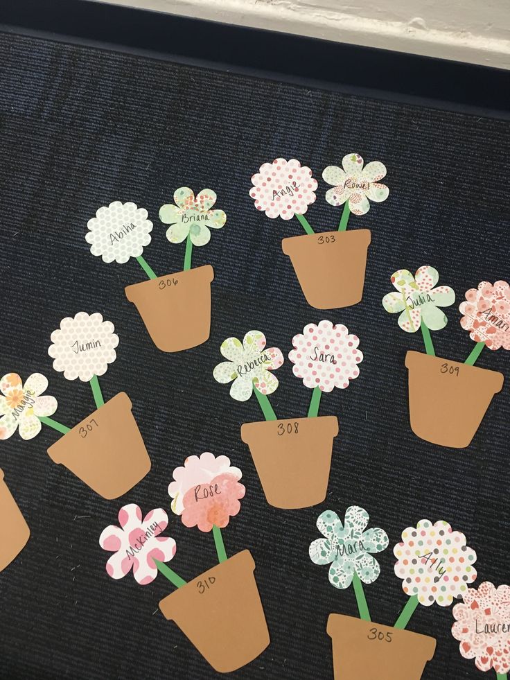 a group of flower pots with flowers in them on a black tablecloth covered surface