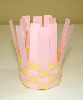 a pink and yellow paper basket on a table