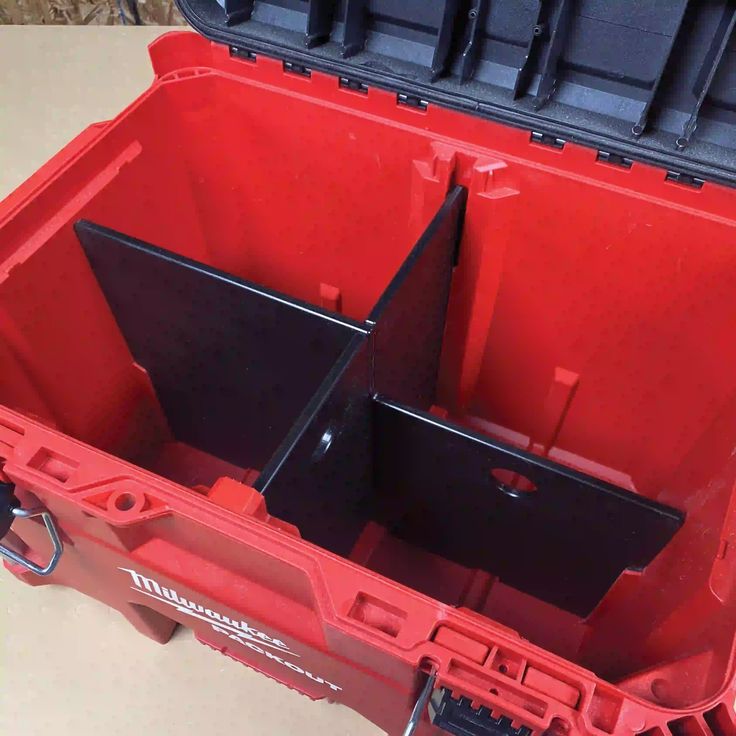 the inside of a red tool box with two open doors and one closed on top